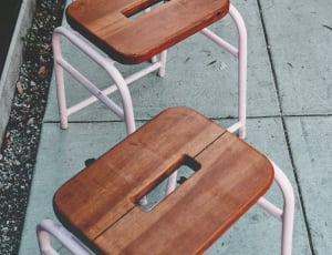 2 brown and pink wooden stools thumbnail