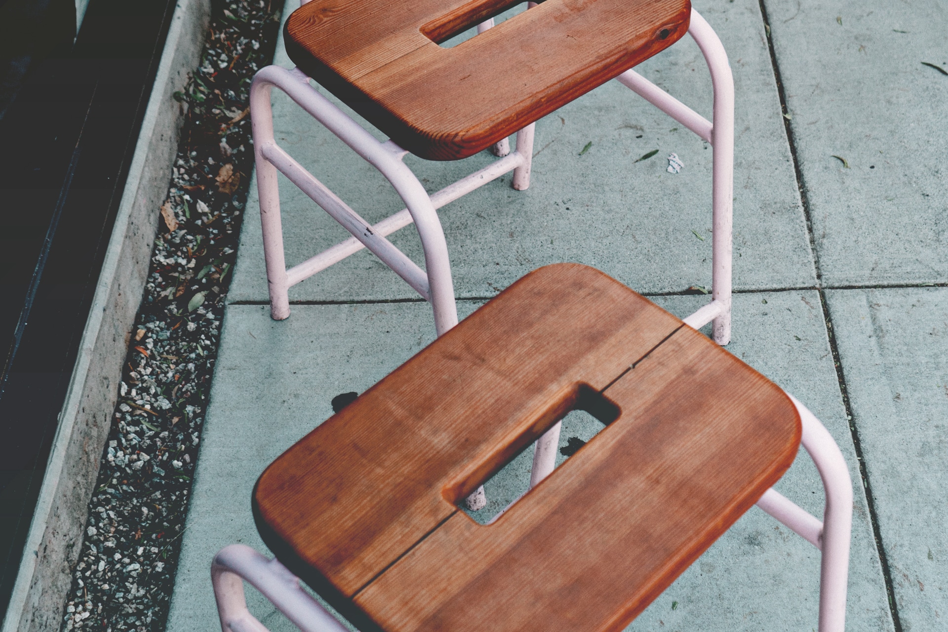 2 brown and pink wooden stools