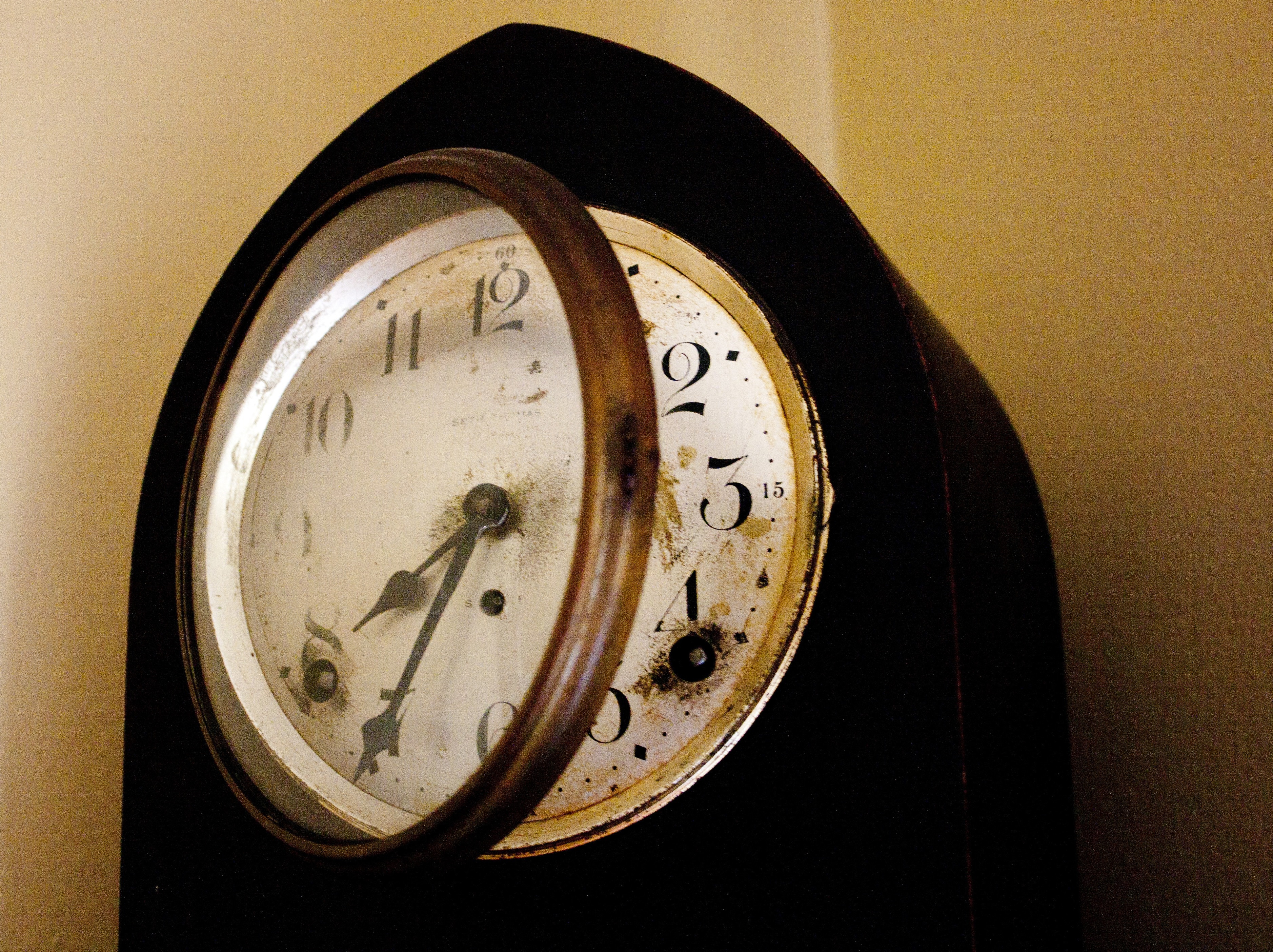 black and white analog clock at 7:35