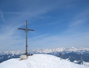 landscape photograph of snow mountain and gothic cross thumbnail