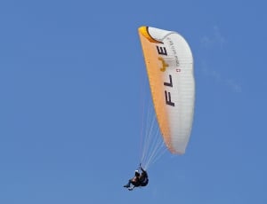 person in paragliding under blue sky thumbnail