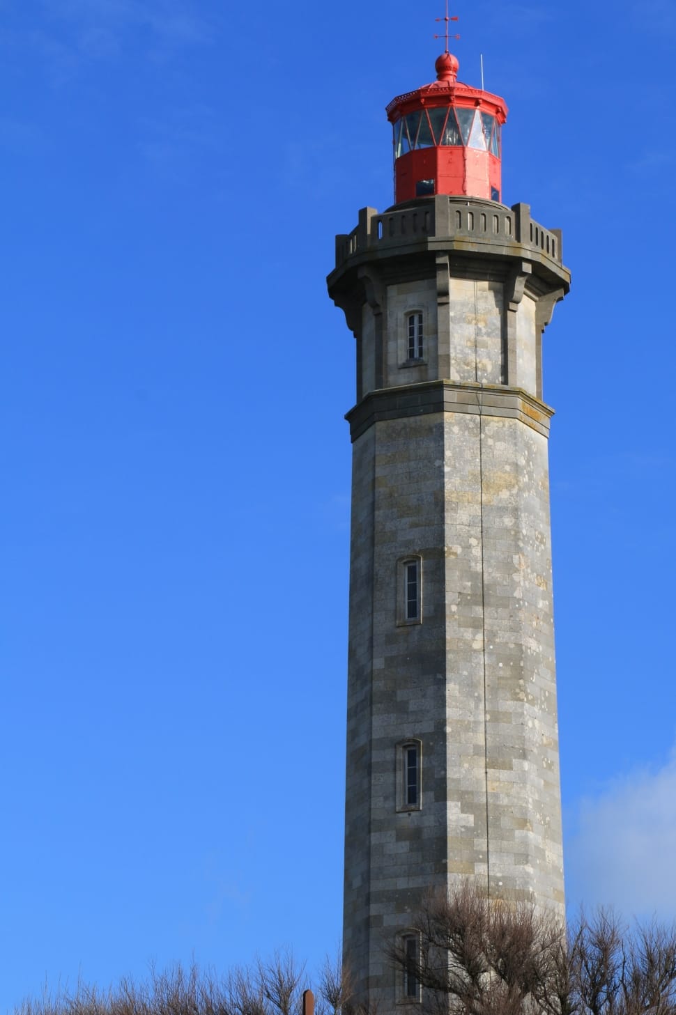 architectural photography of a gray lighthouse under the blue skies preview