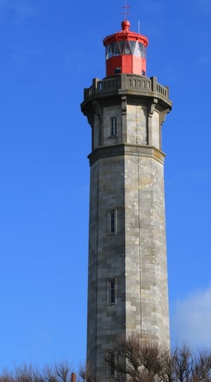 architectural photography of a gray lighthouse under the blue skies thumbnail