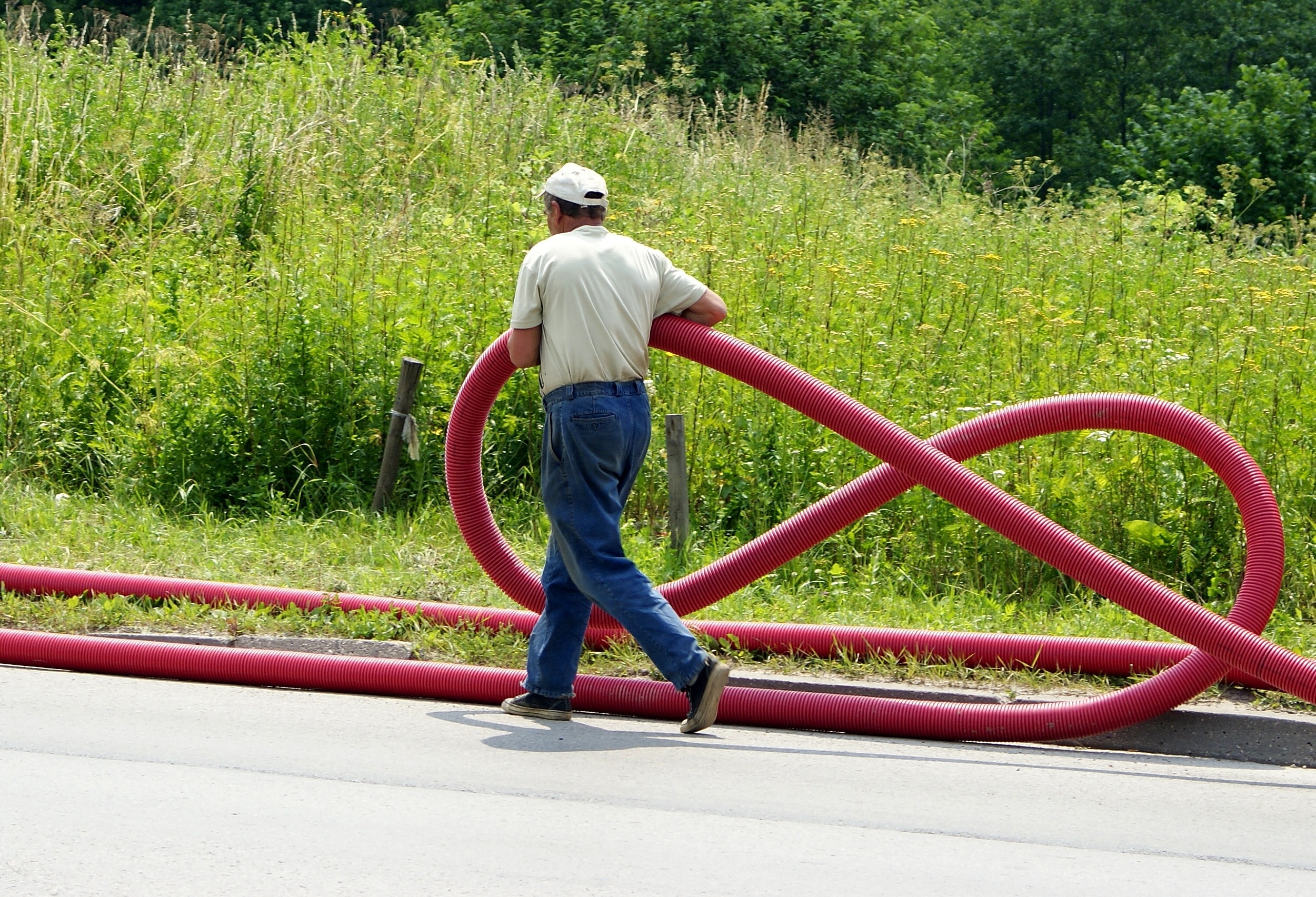 man holding pink hose