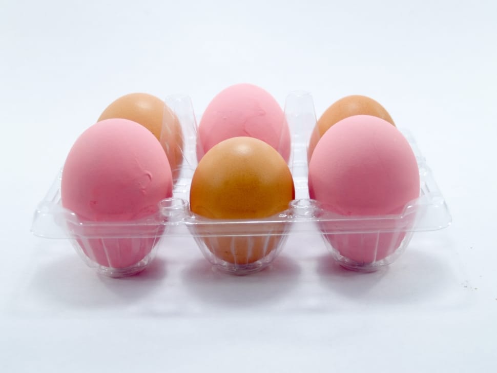 6 brown and pink eggs on plastic container preview