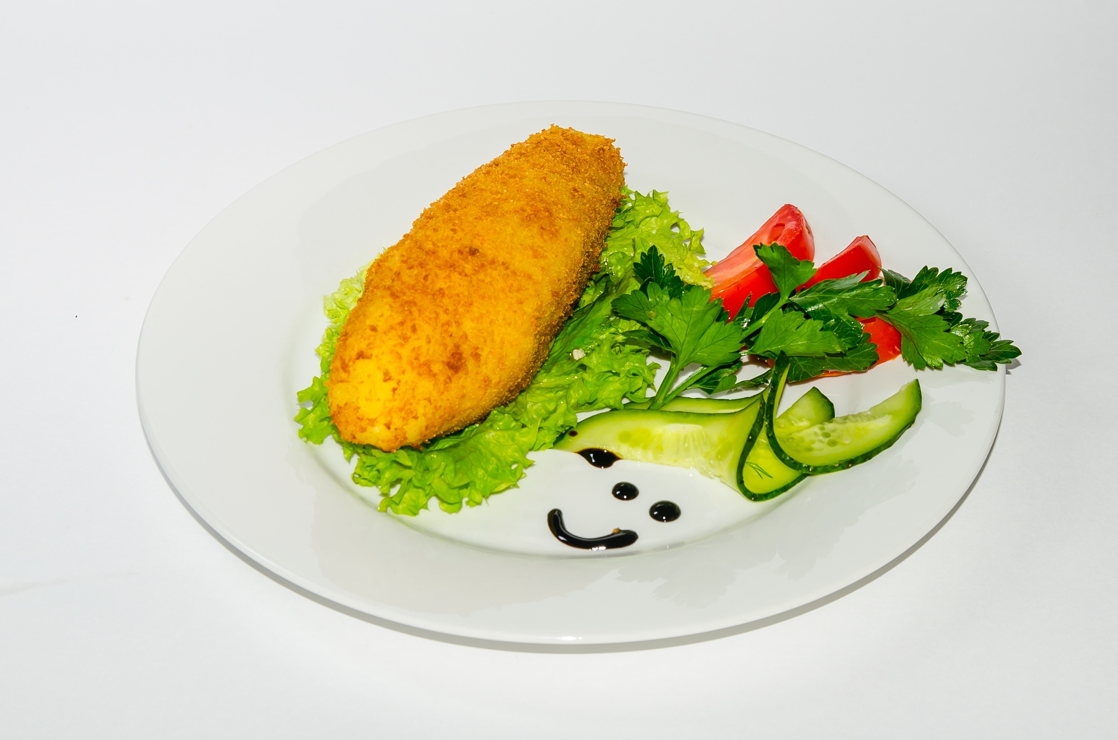 white ceramic plate serve with variety of vegetable with fried food