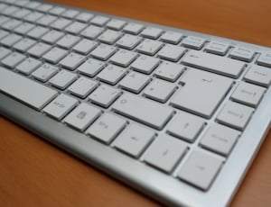 tenkeyless keyboard on brown wooden surface thumbnail