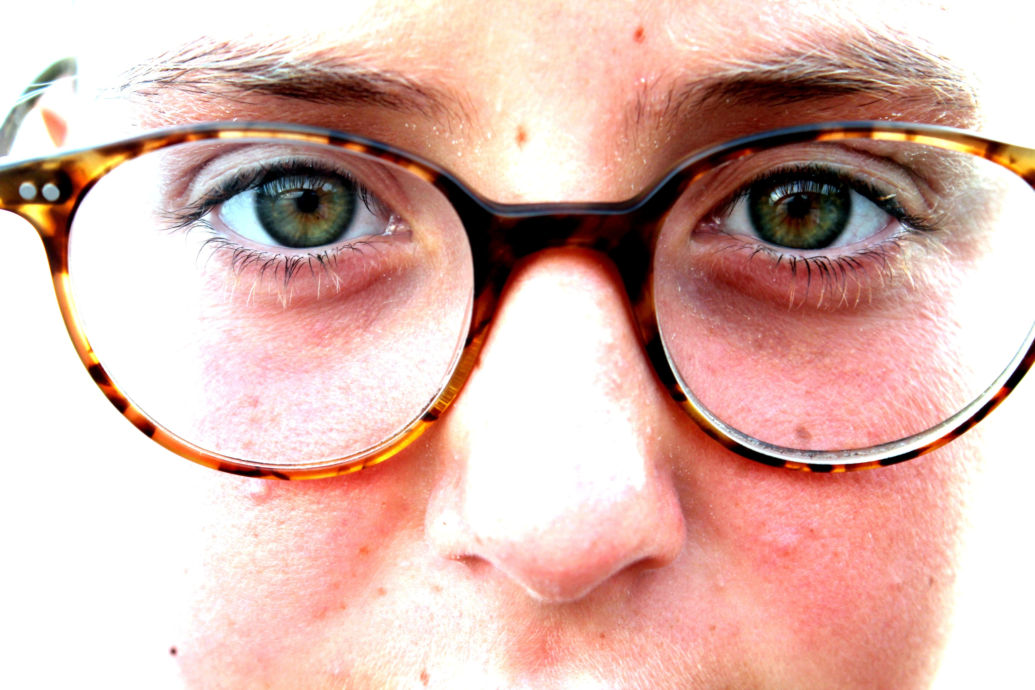 closeup photo of person face wearing eyeglasses