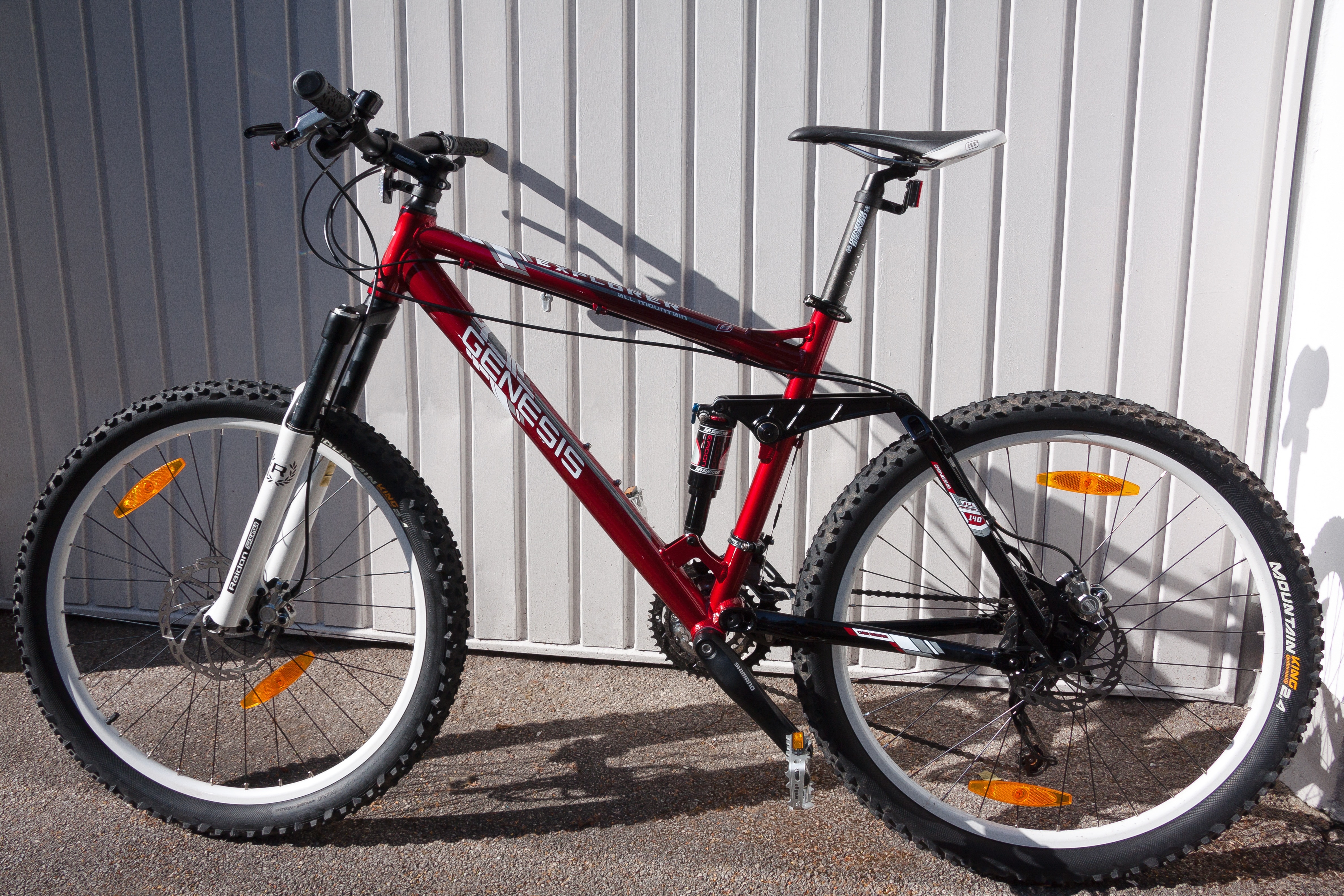 red black full suspension genesis mountain bike