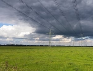 electric posts under nimbus clouds during daytime thumbnail
