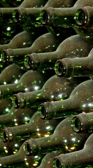 arrangement of green glass bottle lot in closeup photography thumbnail