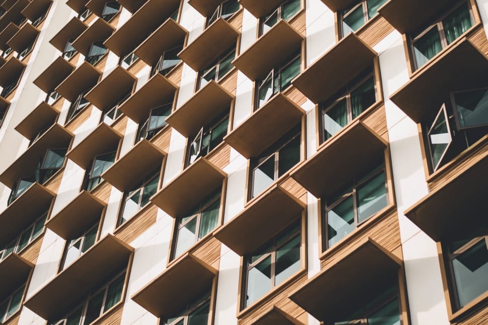 brown and white multi storey building with glass windows preview