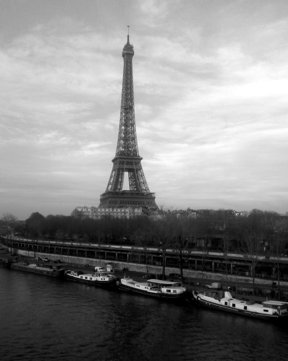 greyscale photo of eiffel tower near river preview