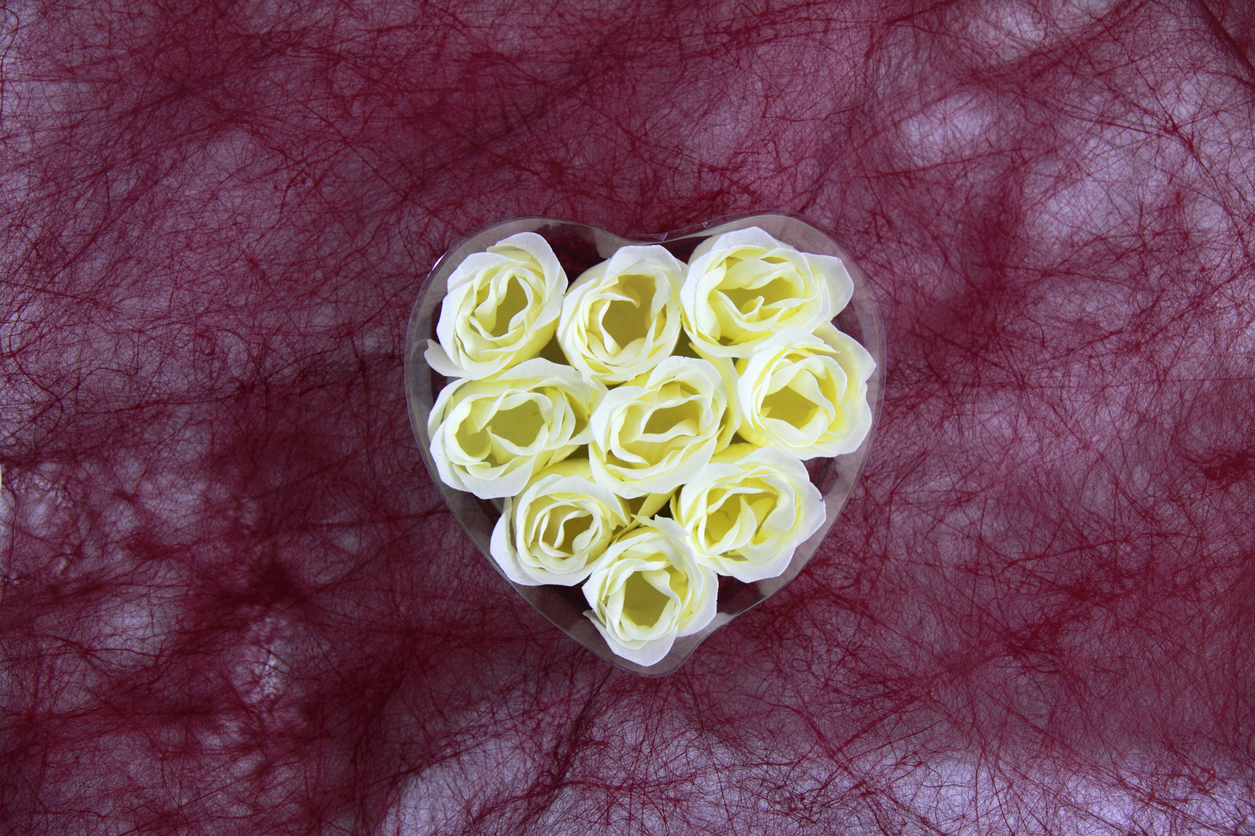 white roses in heart shape rack