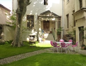 white and pink outdoor table with chairs set on lawn thumbnail