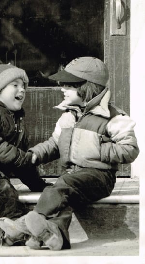 grayscale photo of two boy laughing thumbnail
