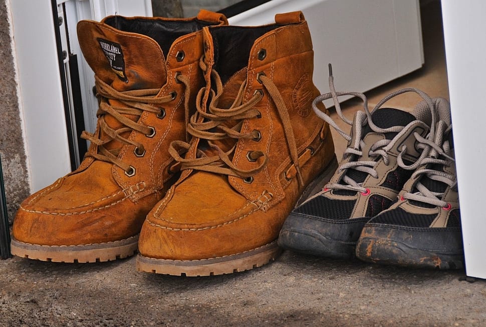 brown leather workboots and black and gray lace up sneakers preview