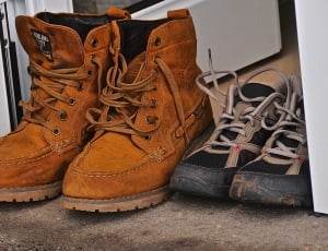 brown leather workboots and black and gray lace up sneakers thumbnail