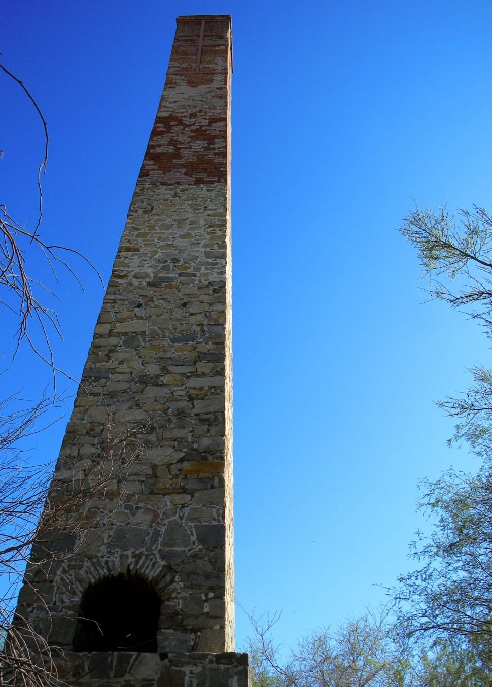 white and red concrete chimney during daytime preview