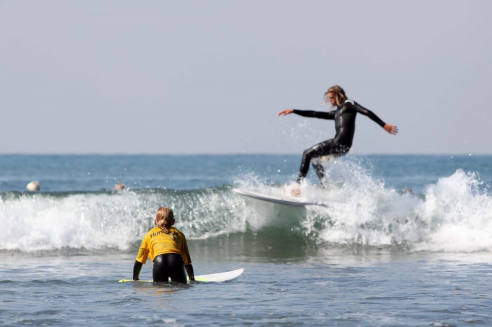 2 woman with surfing boards preview
