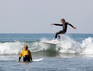 2 woman with surfing boards thumbnail
