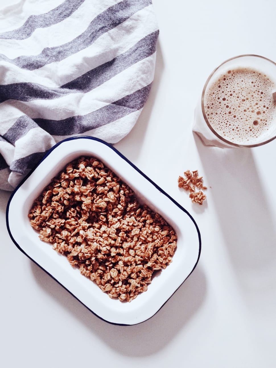crushed peanut of rectangular white ceramic food tray on white table near clear drinking glass preview