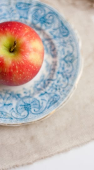 red apple fruit and white and blue ceramic plate thumbnail