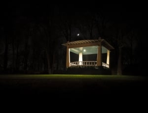 white painted concrete structure on green grass field during night time thumbnail