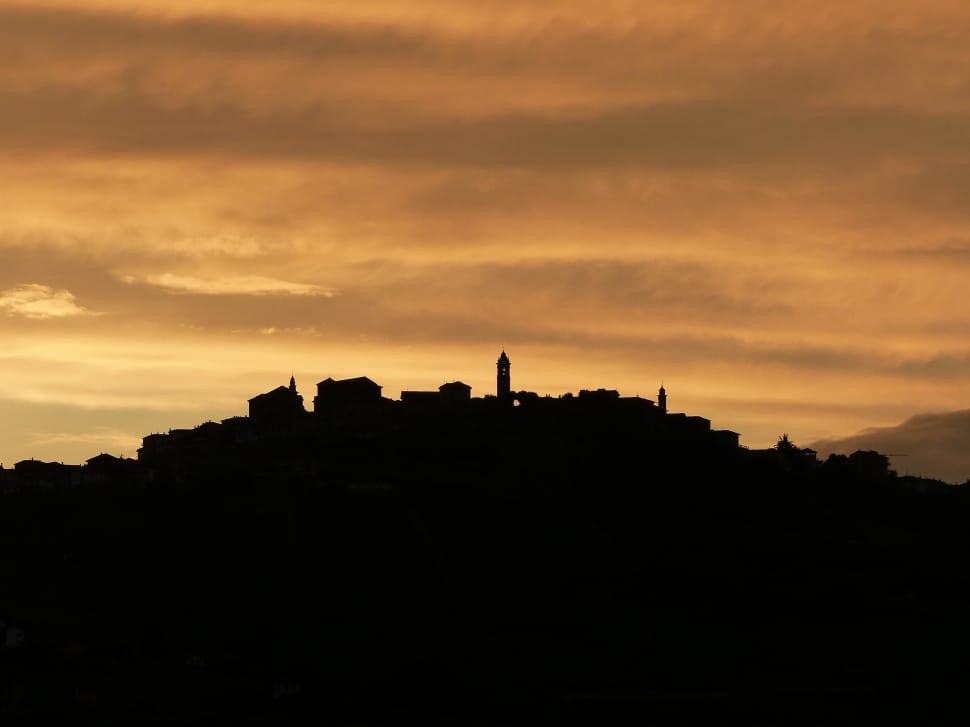 silhouette of village on hill preview
