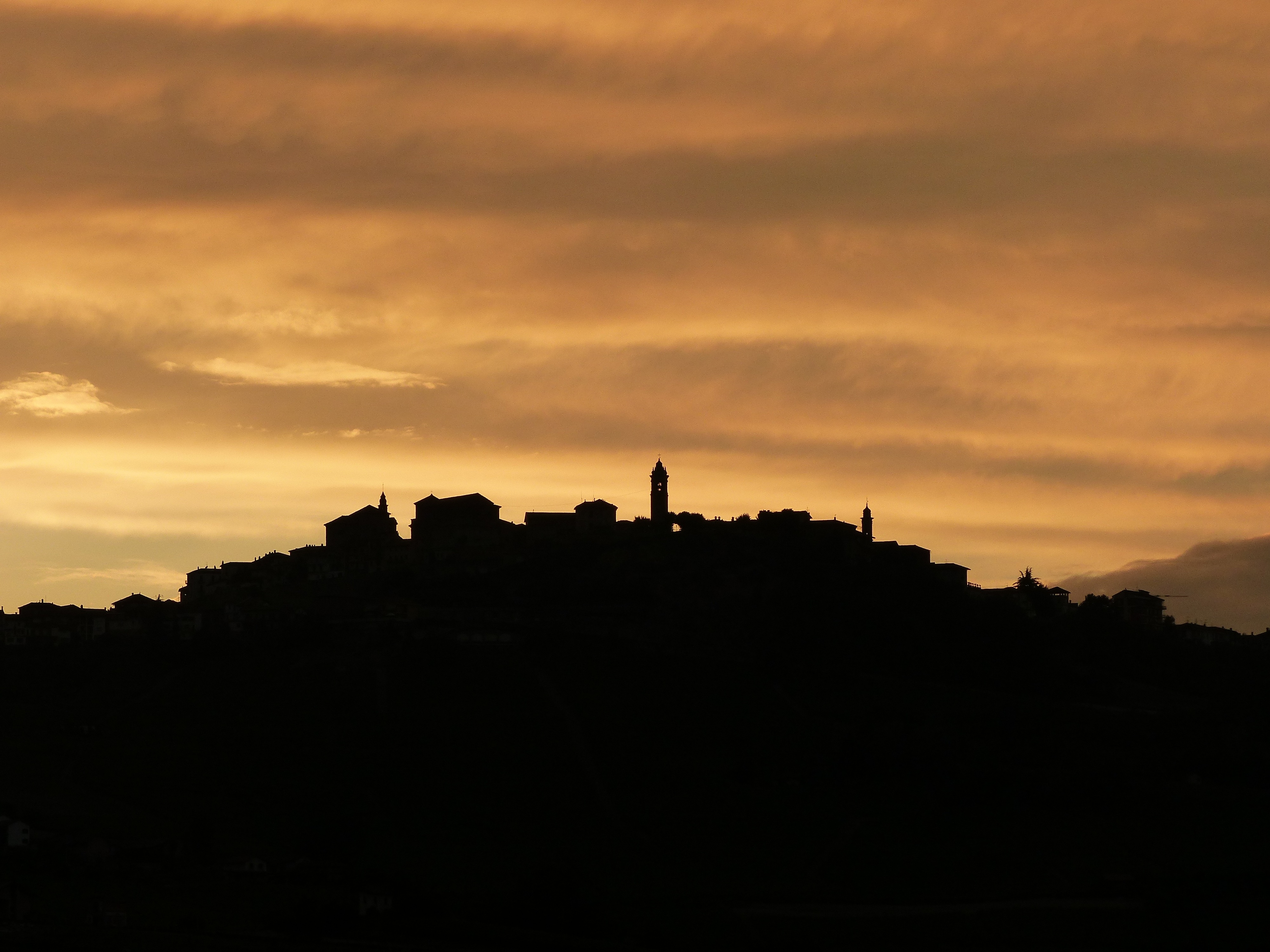 silhouette of village on hill