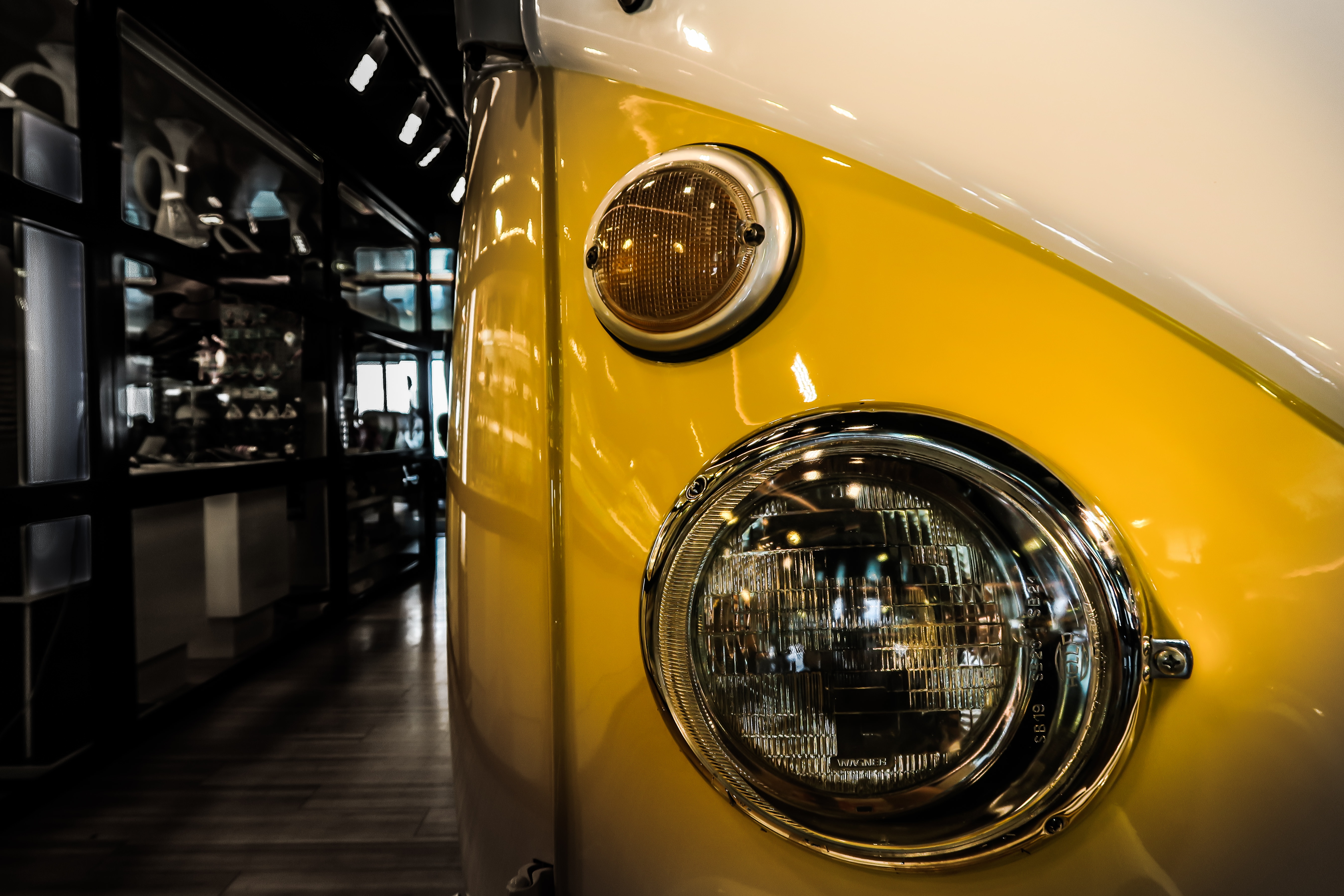 yellow and white classic car inside the room