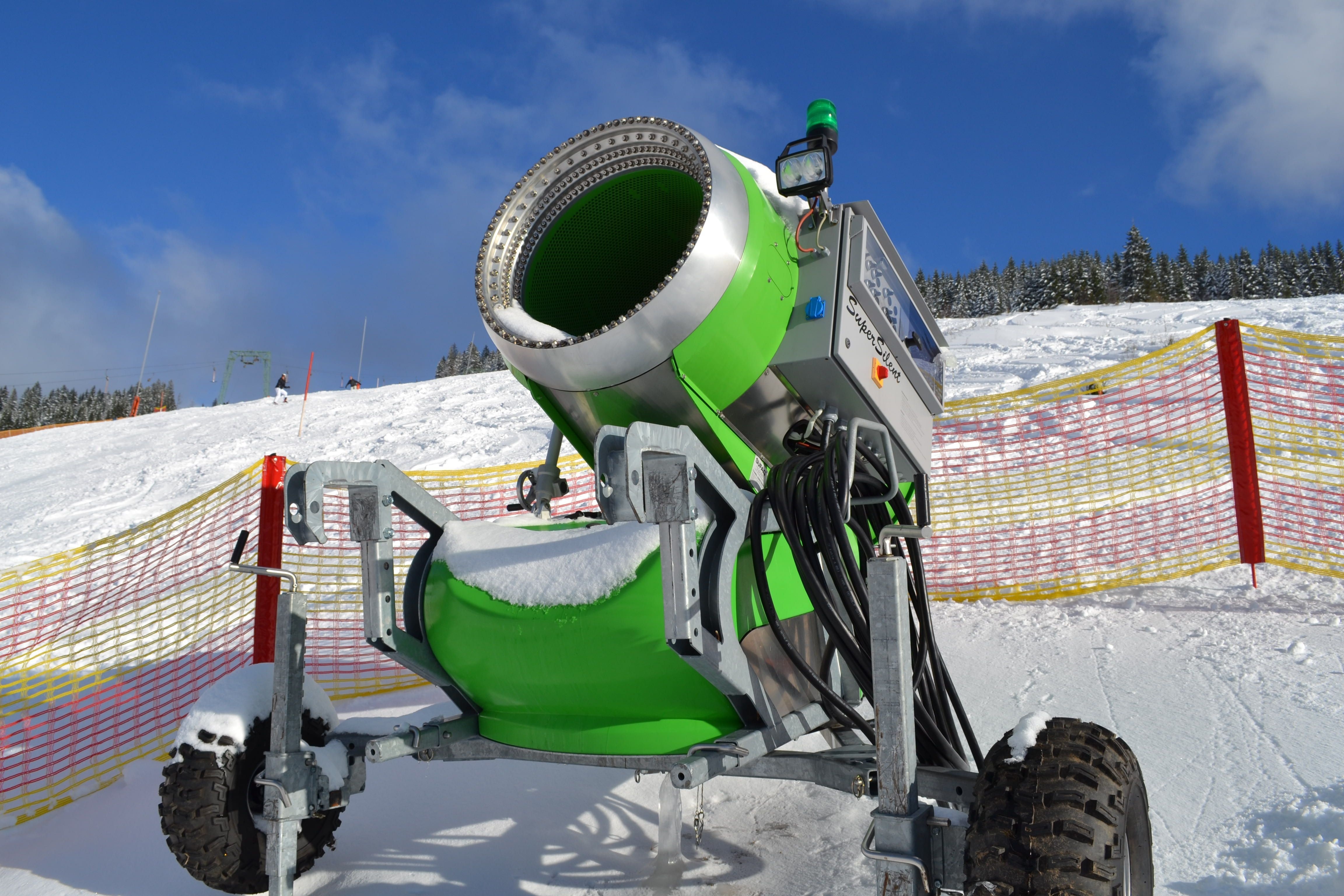 green and gray industrial snow thrower