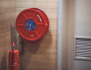 red emergency hose reel near fire extinguisher thumbnail