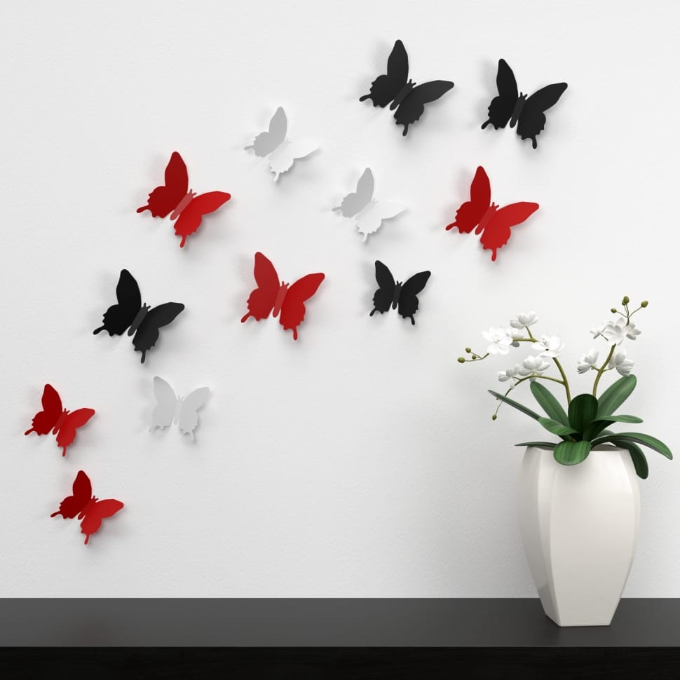 white, black, and red butterflies wall decor near white and green indoor plants preview