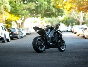 black naked motorcycle in road during daytime thumbnail