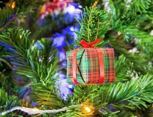 close up photography of pendant gift box christmas tree decor thumbnail