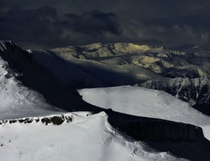 black mountain filled with snow during winter thumbnail
