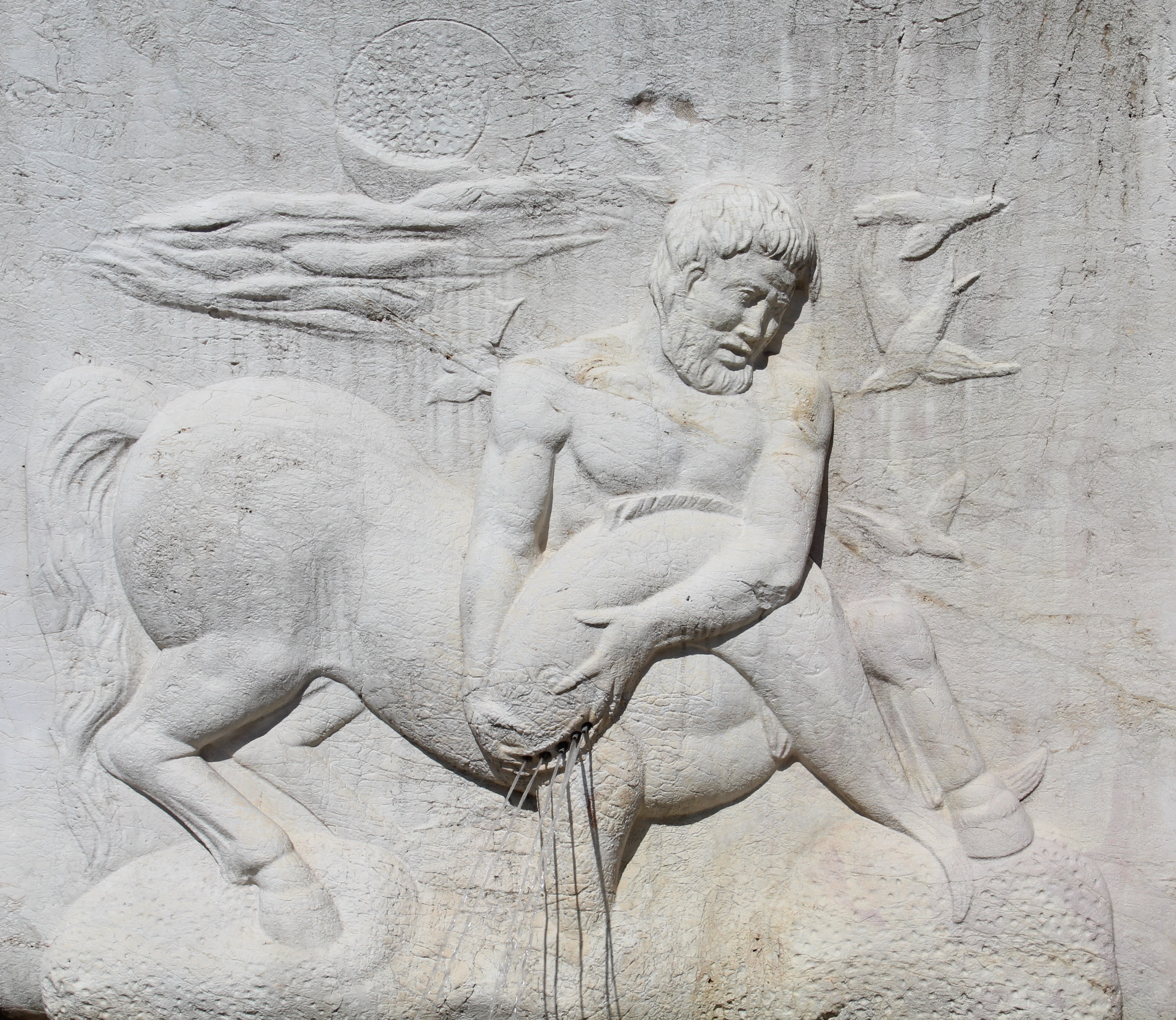 grey stone centaur wall sculpture