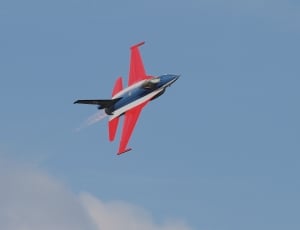 red white and black jet in mid air at daytime thumbnail