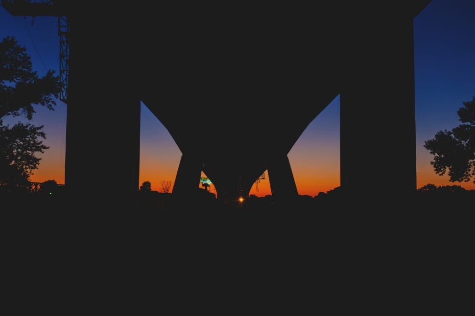 silhouette of bridge and trees during sunset preview
