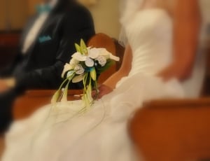 shallow focus photo of bride's bouquet of flowers thumbnail