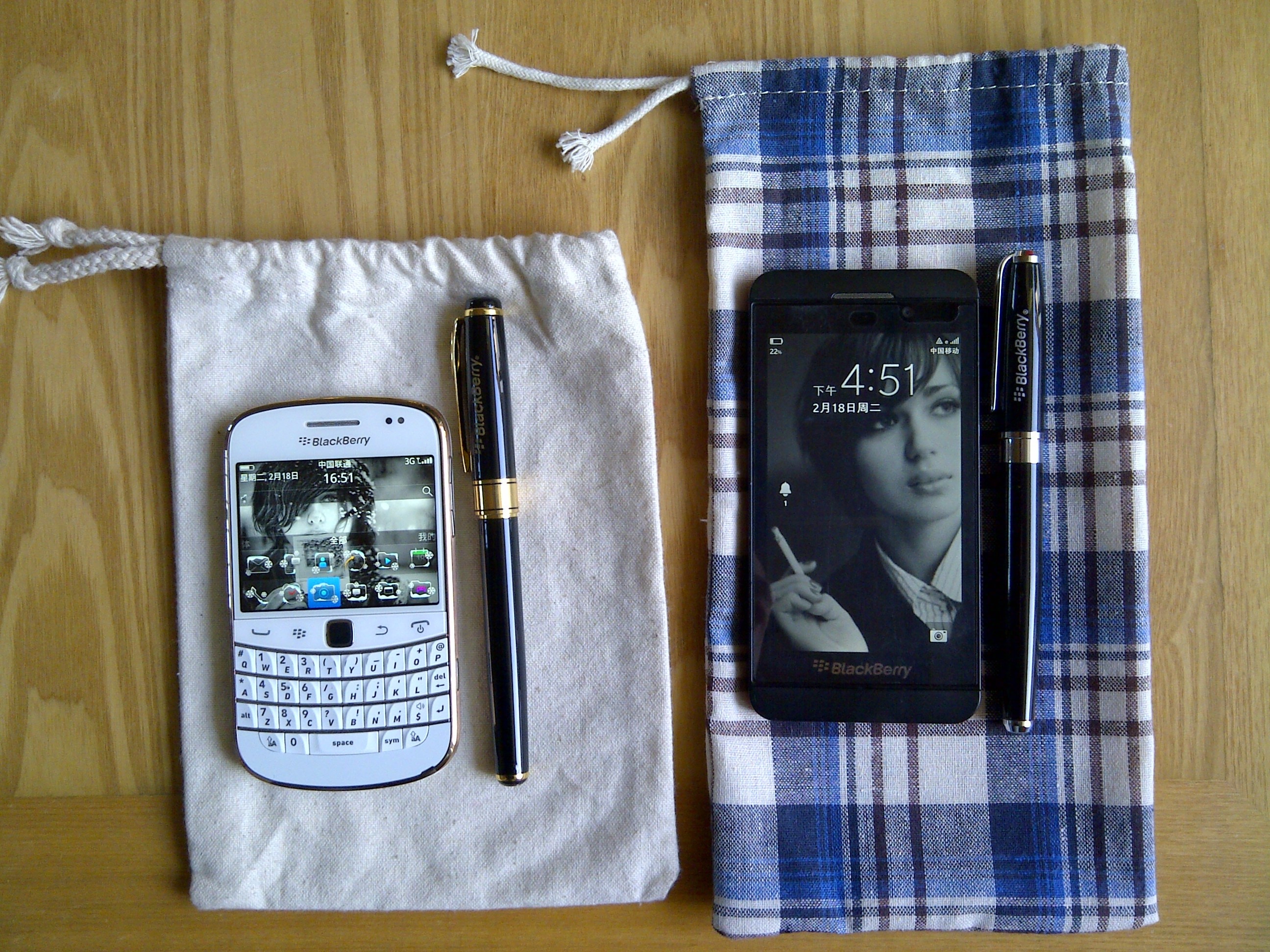 white blackberry qwerty phone and black berry smartphone