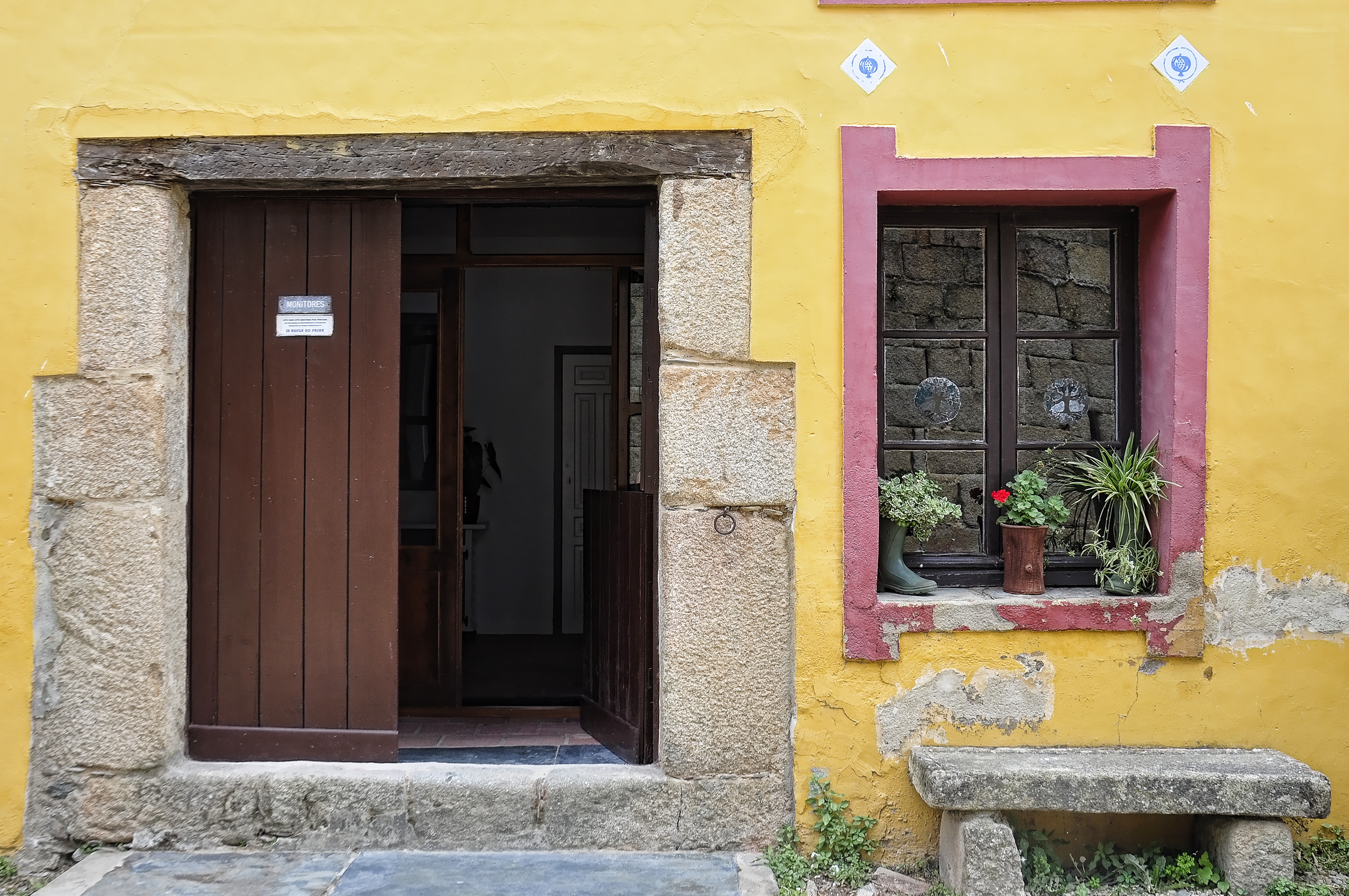 brown door, window, yellow wall