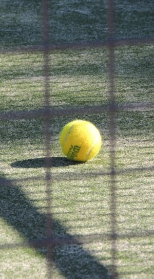 yellow lawn tennis ball on field thumbnail