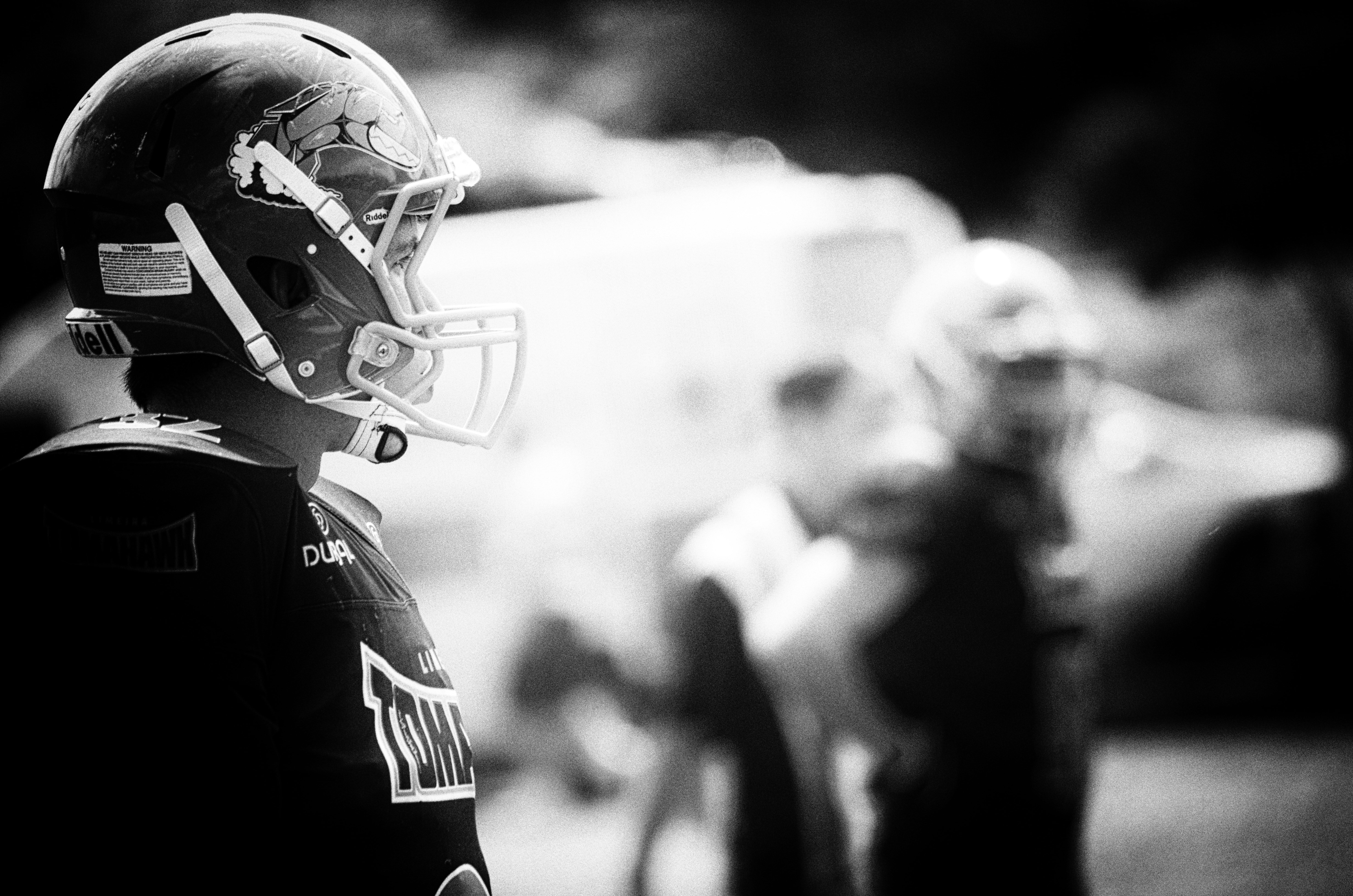 gray scale macro shot of nfl player
