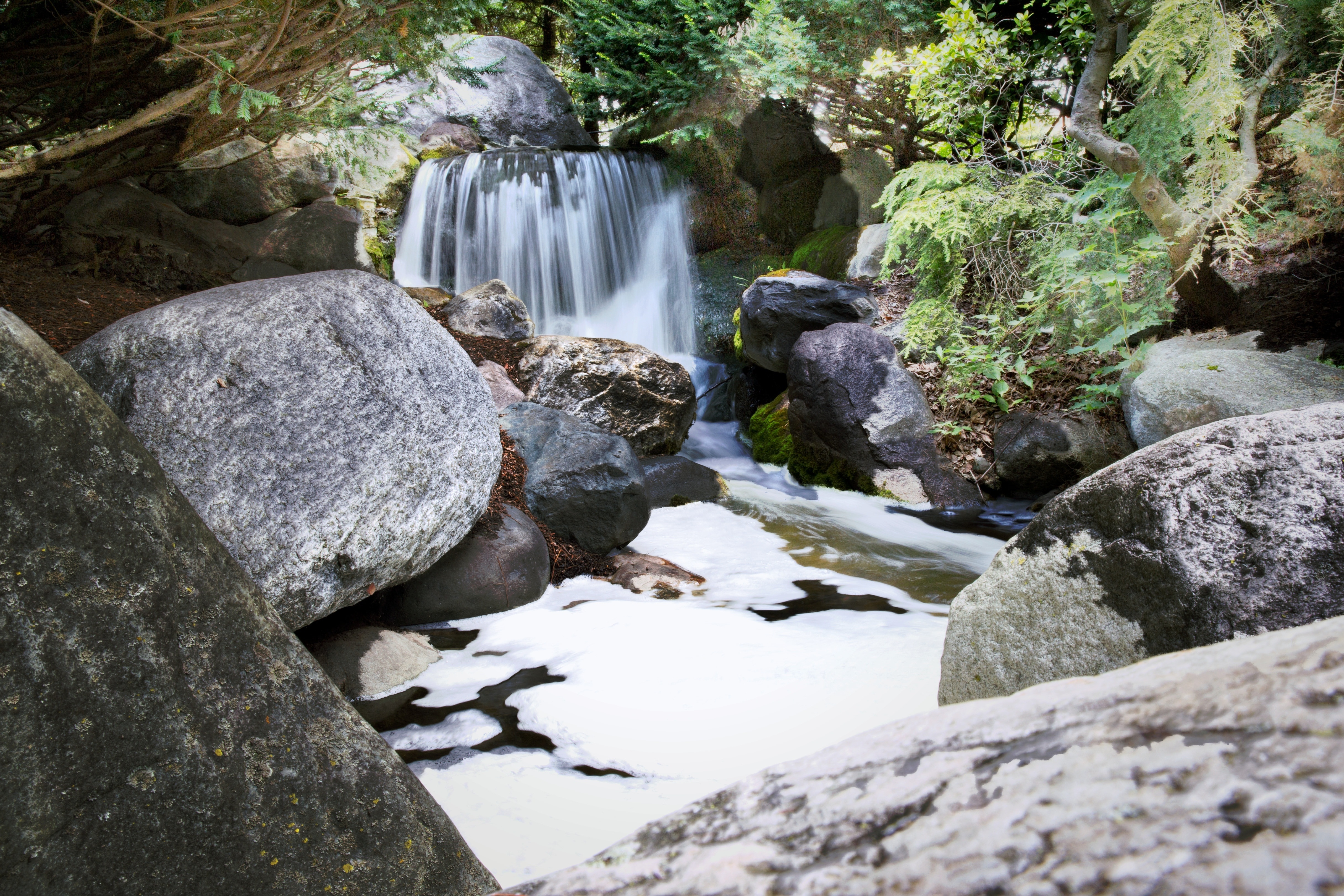 waterfalls passes through boulder timelapse photography