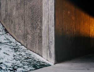 brown concrete wall near white snow ground during golden hour thumbnail