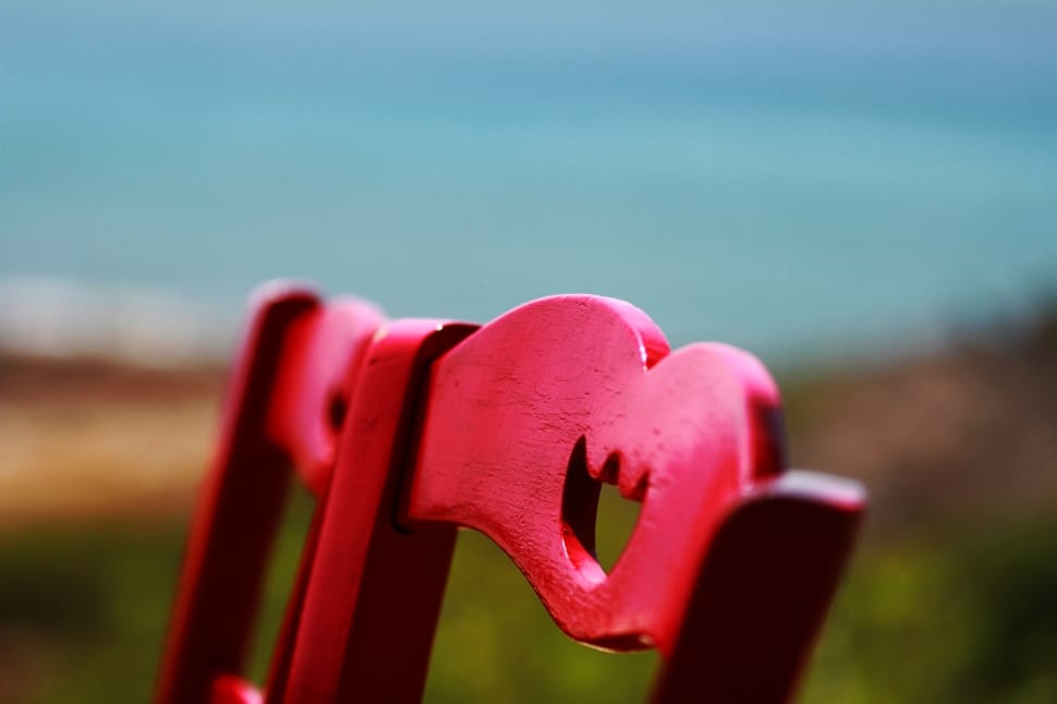 close up photo of two red wooden chair preview