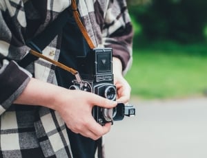 person holding black camera during daytime thumbnail