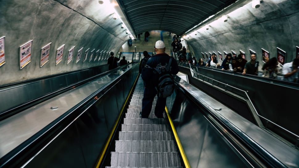 person riding on escalator photo preview